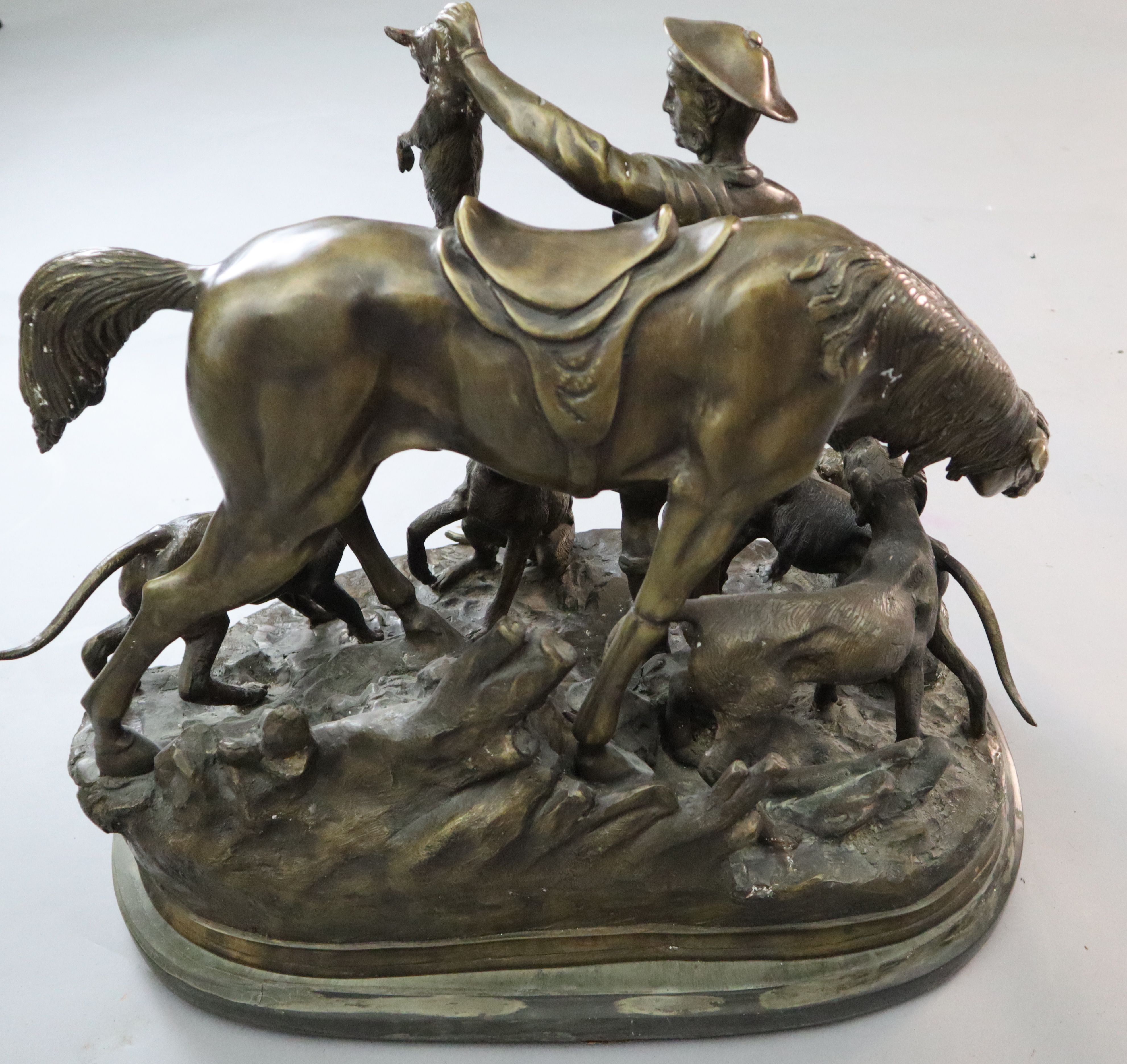 After Pierre Jules Mene. A bronze group of a ghillie, pony and hounds, width 23in. height 20in.